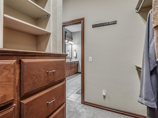 walk in closet featuring light tile patterned floors and light carpet