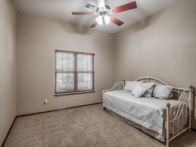 carpeted bedroom featuring baseboards, ceiling fan, and visible vents