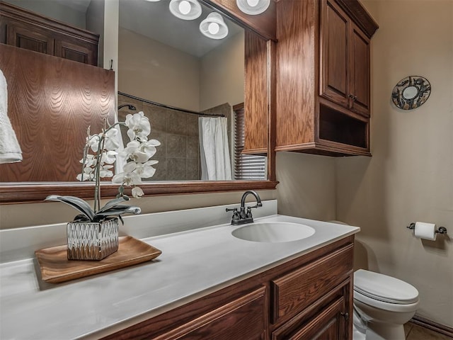 bathroom featuring vanity, a shower with shower curtain, and toilet