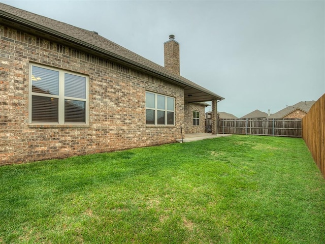 view of yard featuring a fenced backyard and a patio area