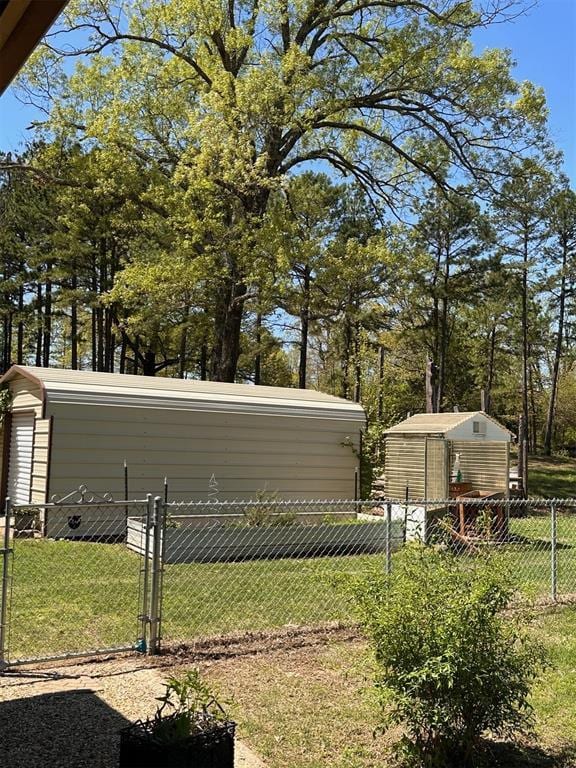 view of yard featuring fence and an outdoor structure