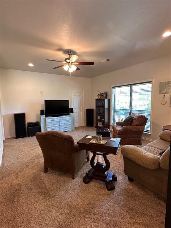carpeted living area featuring ceiling fan, baseboards, visible vents, and recessed lighting