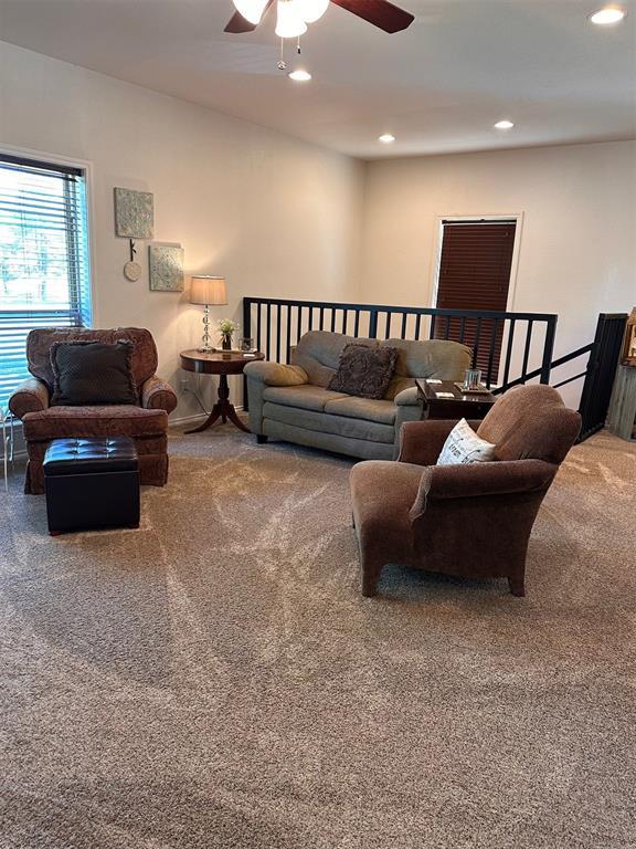 living area with recessed lighting, carpet flooring, and ceiling fan