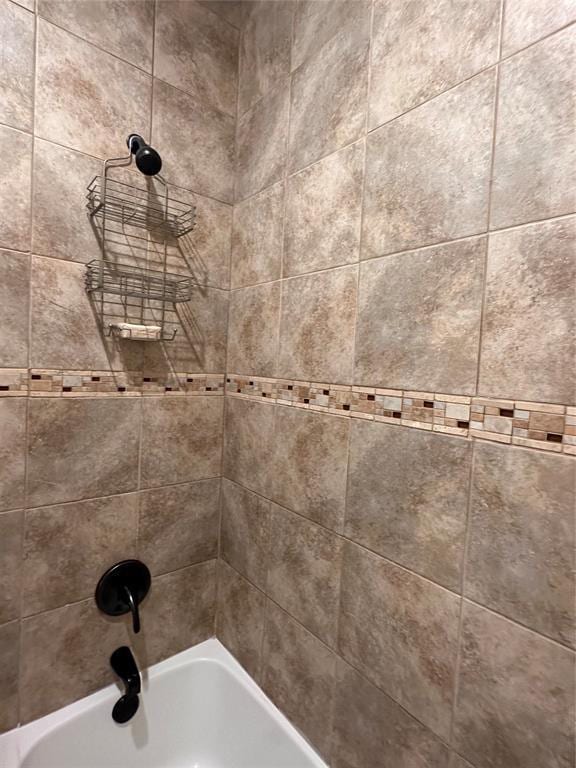 room details featuring shower / washtub combination