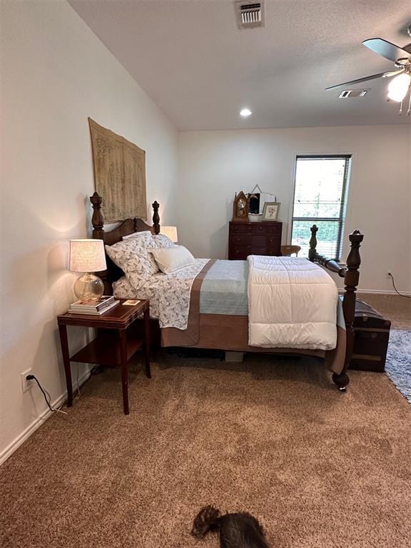 carpeted bedroom with ceiling fan, baseboards, and visible vents