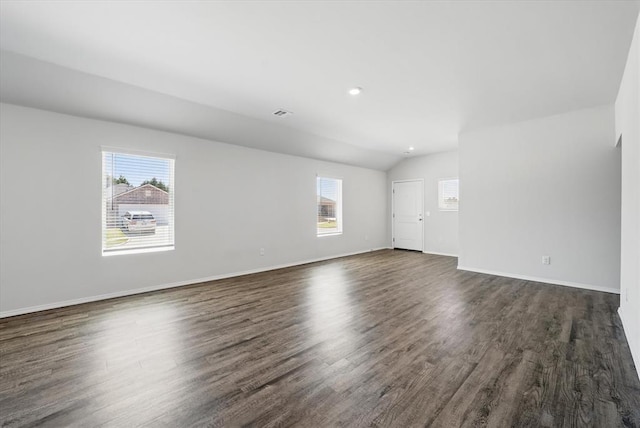 unfurnished living room with vaulted ceiling, baseboards, and dark wood finished floors