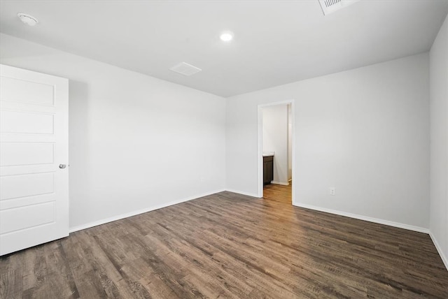 spare room with visible vents, baseboards, wood finished floors, and recessed lighting
