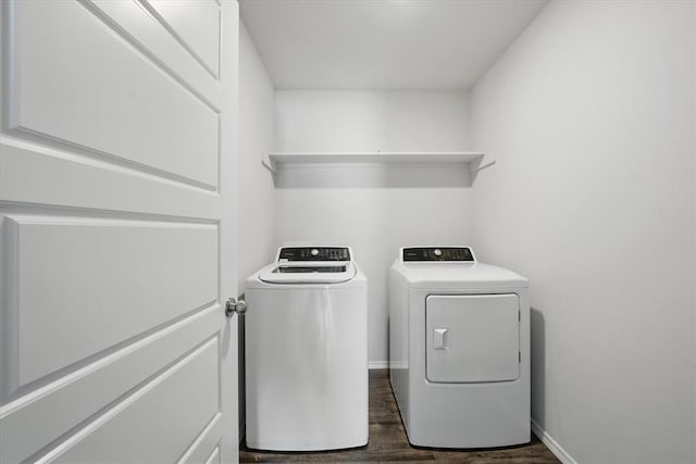 laundry area featuring baseboards, washer and clothes dryer, laundry area, and dark wood-style flooring