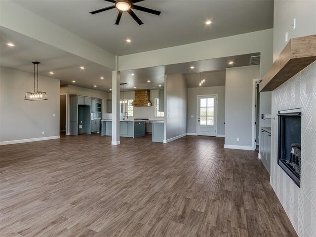 15528 NE 36th St, Choctaw, OK 73020 - unfurnished living room with a sink, ceiling fan, a tiled fireplace, dark wood-style flooring, and visible vents
