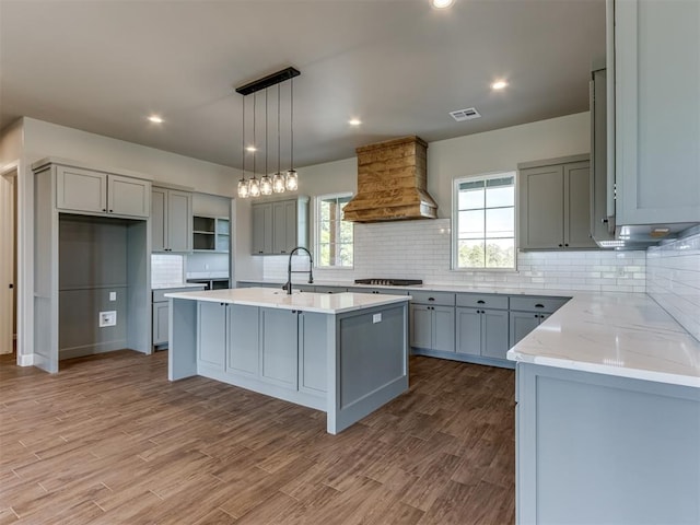 15528 NE 36th St, Choctaw, OK 73020 - kitchen featuring stainless steel gas cooktop, a sink, visible vents, custom range hood, and gray cabinets
