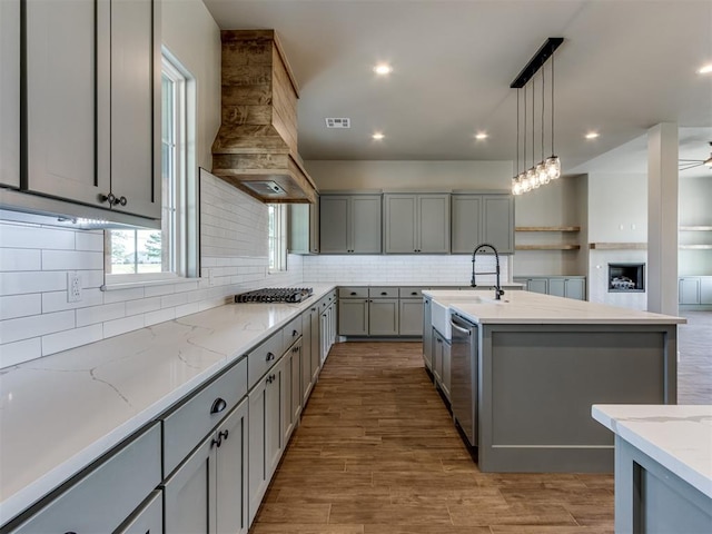 15528 NE 36th St, Choctaw, OK 73020 - kitchen featuring premium range hood, tasteful backsplash, gray cabinetry, and appliances with stainless steel finishes