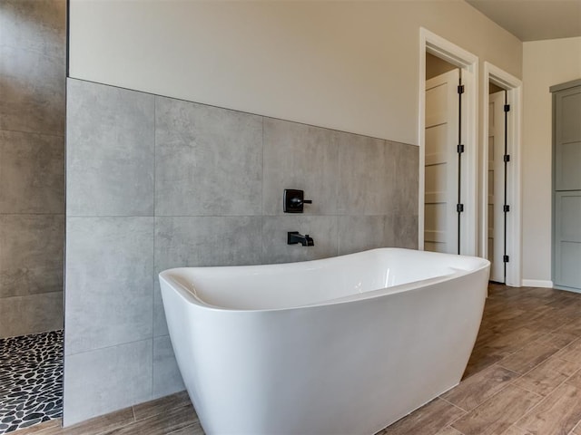 15528 NE 36th St, Choctaw, OK 73020 - bathroom featuring a freestanding bath and wood finished floors