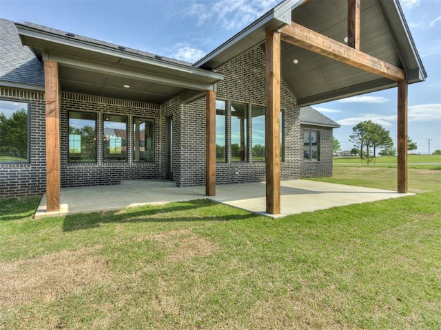 15528 NE 36th St, Choctaw, OK 73020 - rear view of house featuring brick siding, a yard, and a patio area