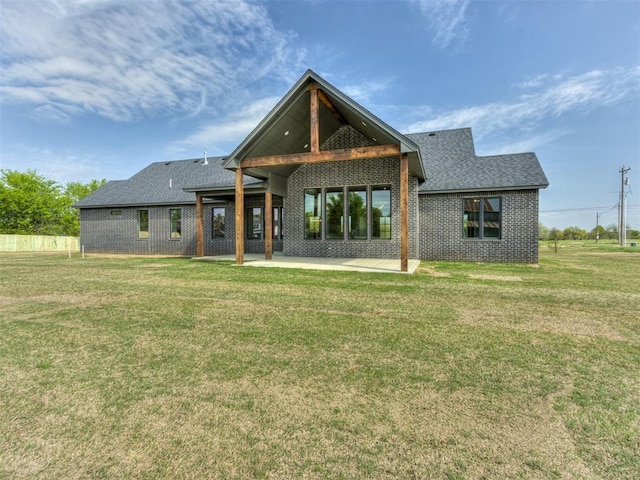 15528 NE 36th St, Choctaw, OK 73020 - rear view of house with a lawn, brick siding, roof with shingles, and a patio