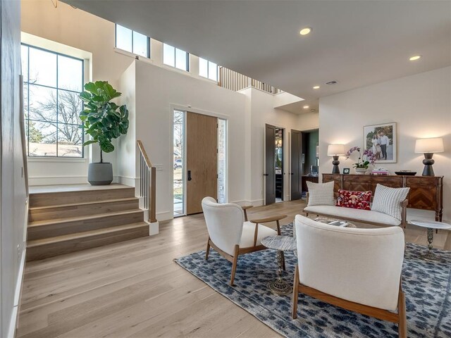 2320 Belleview Dr, Oklahoma City, OK 73112 - living area featuring a wealth of natural light, recessed lighting, stairway, and light wood-type flooring