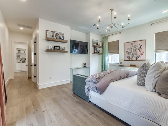 2320 Belleview Dr, Oklahoma City, OK 73112 - bedroom featuring light wood-type flooring, an inviting chandelier, baseboards, and visible vents