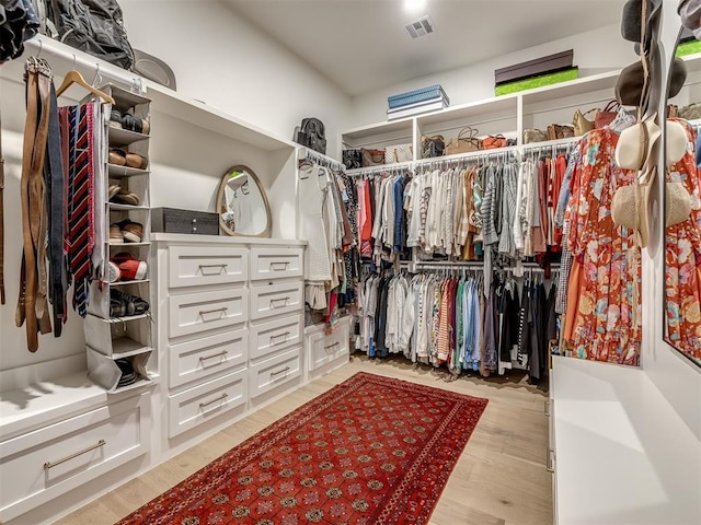 2320 Belleview Dr, Oklahoma City, OK 73112 - walk in closet with light wood-style flooring and visible vents
