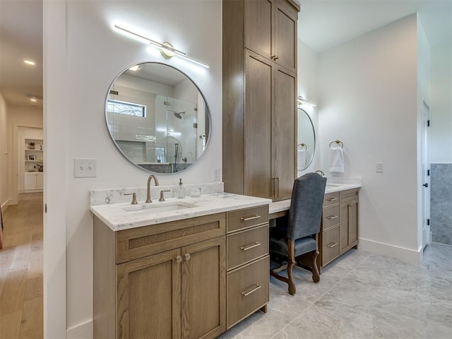 2320 Belleview Dr, Oklahoma City, OK 73112 - bathroom featuring two vanities, a sink, baseboards, and walk in shower