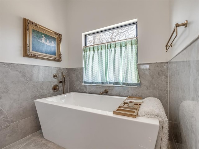 2320 Belleview Dr, Oklahoma City, OK 73112 - bathroom featuring wainscoting, tile walls, and a soaking tub