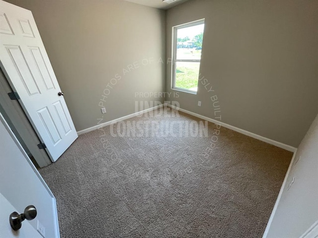unfurnished bedroom featuring carpet flooring and baseboards