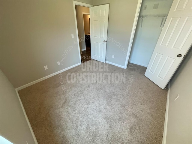 unfurnished bedroom with a closet, carpet flooring, and baseboards