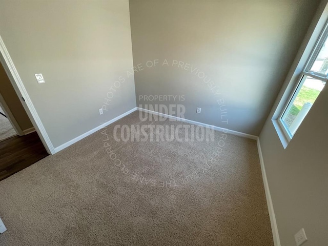 empty room with baseboards and carpet flooring