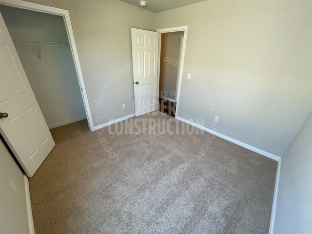 unfurnished bedroom featuring a closet, baseboards, and carpet