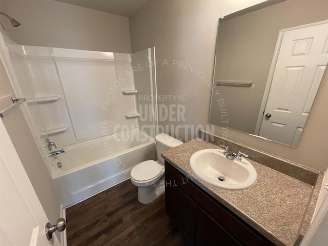 bathroom with vanity, shower / tub combination, toilet, and wood finished floors