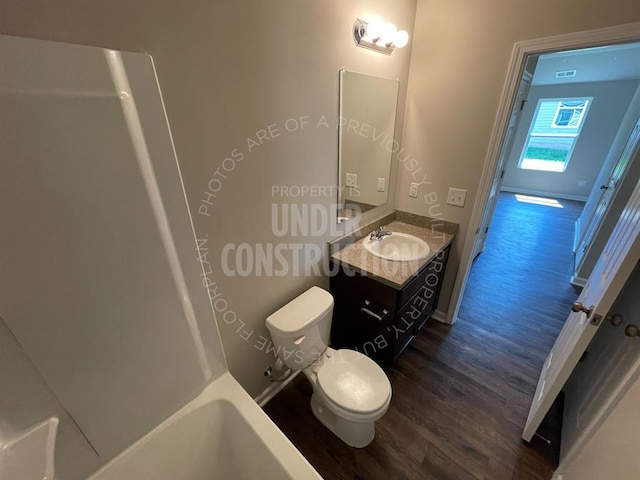 bathroom featuring vanity, baseboards, toilet, and wood finished floors