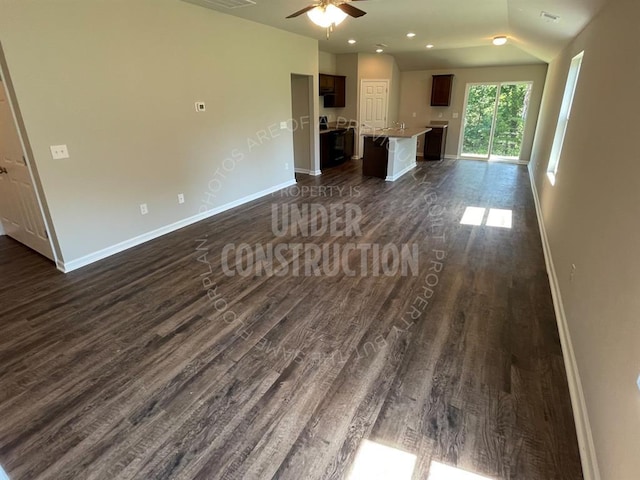 unfurnished living room featuring ceiling fan, baseboards, dark wood-style floors, and visible vents