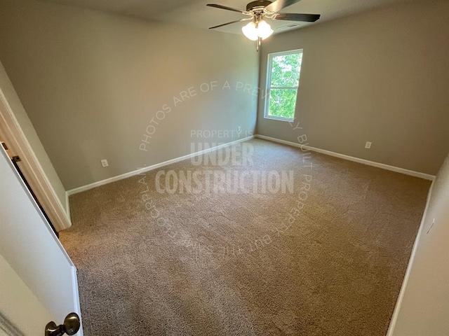 carpeted spare room featuring baseboards and ceiling fan
