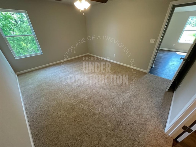 spare room with carpet flooring, ceiling fan, and baseboards