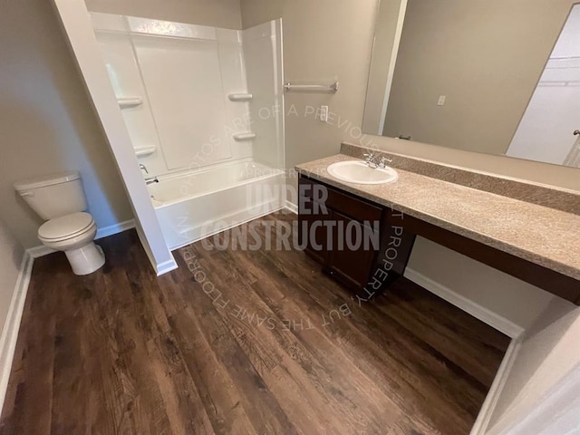 full bathroom with washtub / shower combination, toilet, vanity, and wood finished floors