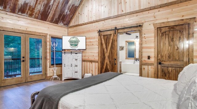 bedroom with wood walls, high vaulted ceiling, and french doors