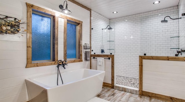 bathroom featuring walk in shower, recessed lighting, a freestanding tub, and wood finished floors