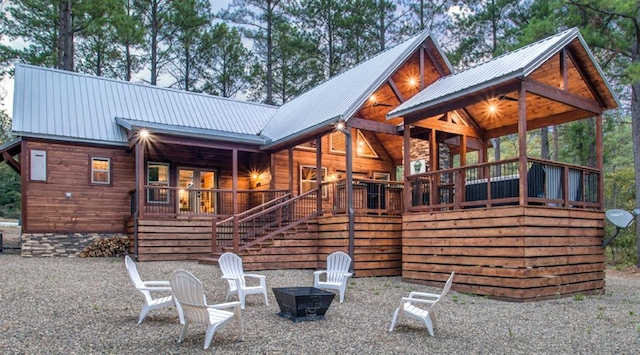 rear view of house featuring an outdoor fire pit, stairway, a patio, and metal roof