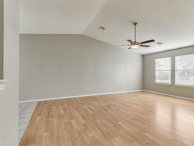 14813 Moon Daisy Dr, Edmond, OK 73013 - empty room with a ceiling fan, visible vents, vaulted ceiling, and light wood-style flooring