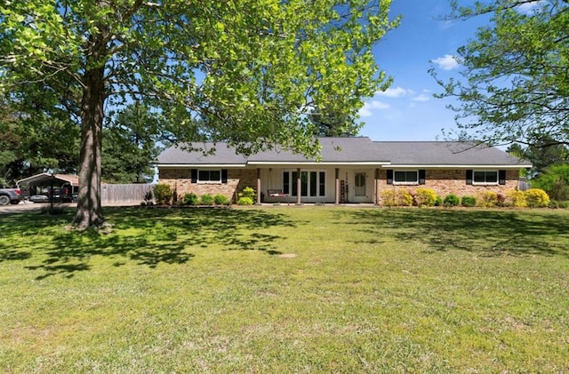 back of house featuring a lawn and fence