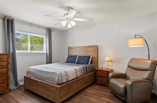 bedroom with dark wood finished floors, a textured ceiling, and a ceiling fan
