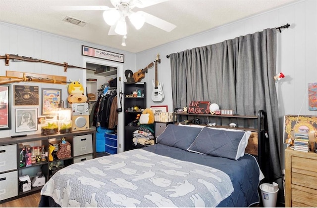 bedroom featuring visible vents, wood finished floors, a closet, and ceiling fan