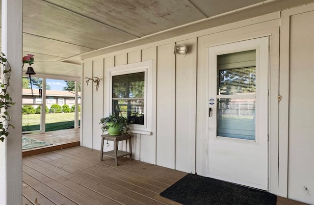 property entrance featuring board and batten siding and a porch
