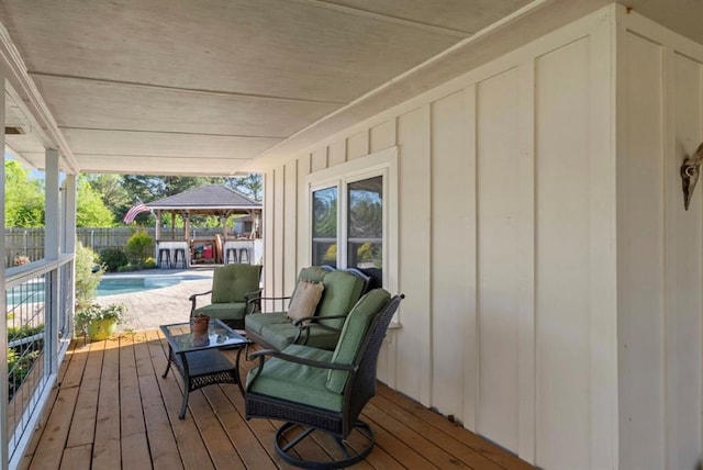wooden terrace featuring a gazebo, fence, and a fenced in pool