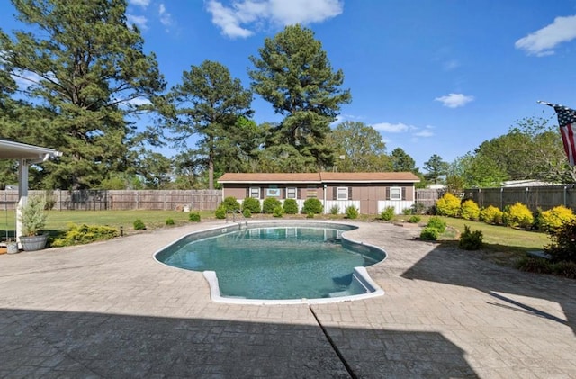 view of swimming pool with a fenced backyard, a yard, a patio area, and a fenced in pool