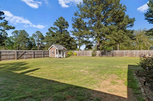 view of yard featuring an outdoor structure, a shed, and a fenced backyard