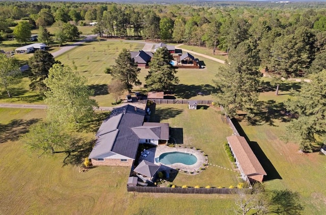 birds eye view of property featuring a view of trees