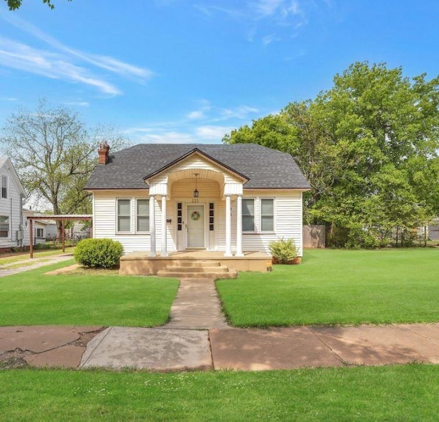 121 S Randlett St, Hobart, OK 73651 - bungalow-style house with a chimney, a shingled roof, a front yard, and covered porch