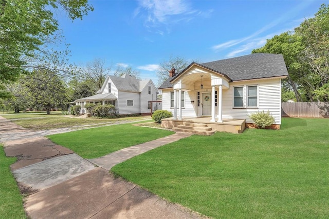 121 S Randlett St, Hobart, OK 73651 - bungalow-style home featuring a front yard, a porch, fence, and a shingled roof