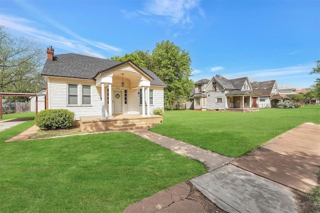 121 S Randlett St, Hobart, OK 73651 - bungalow-style house featuring roof with shingles, a chimney, covered porch, and a front lawn