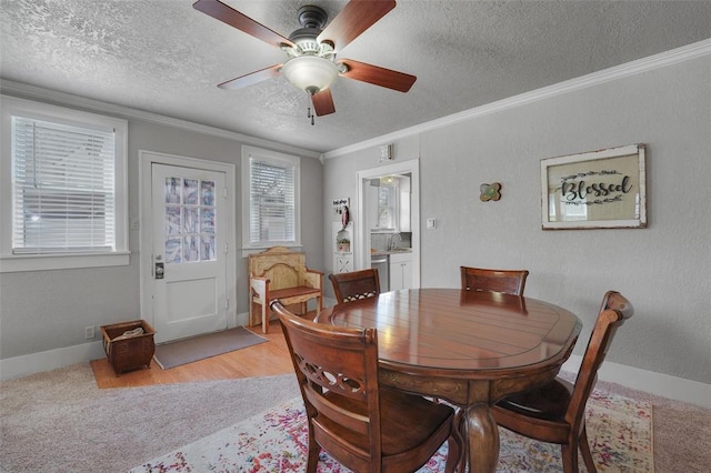 121 S Randlett St, Hobart, OK 73651 - dining area with a textured ceiling, ornamental molding, baseboards, and a ceiling fan