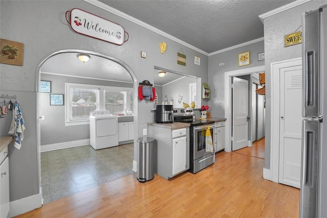121 S Randlett St, Hobart, OK 73651 - kitchen featuring washer / clothes dryer, white cabinetry, crown molding, and appliances with stainless steel finishes